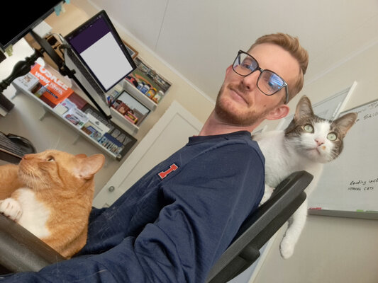 A selfie of me in the office with Beef atop my shoulders and Roland on my lap.