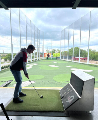 A photo of me about to take a horrible golf swing.