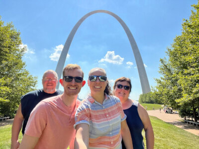 A selfie of me, Emily and her parents in front of the arch in St. Louis.