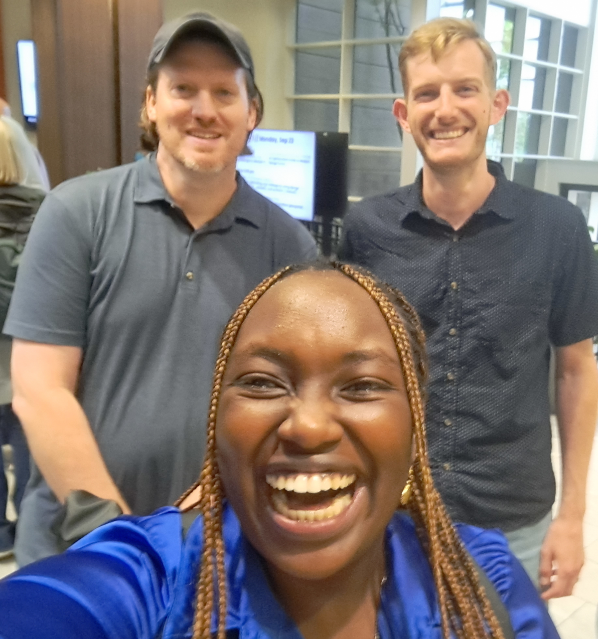 A photo of Velda in the front smiling, with Jeff and myself in the background smiling.