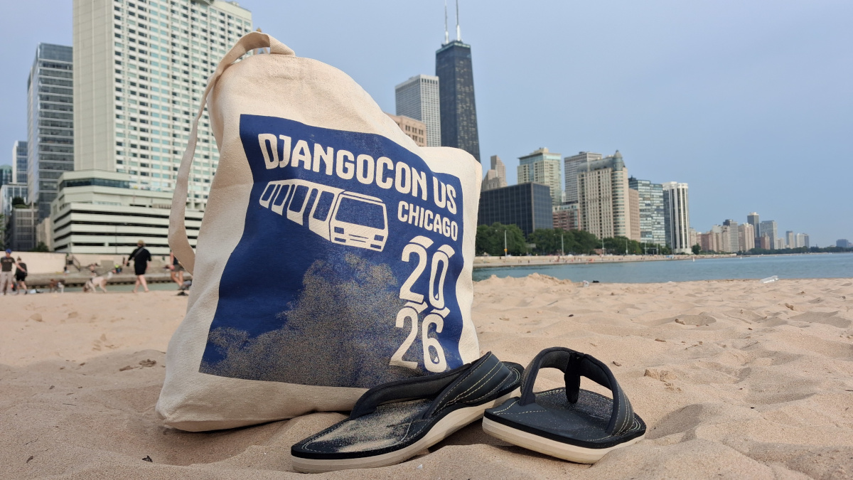 The DjangoCon US 2026 swag bag on the beach with the Chicago skyline in the background.