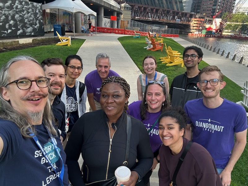 Some of the members of Djangonaut Space gathered along the river for coffee and pastries. Photo credit: Peter Grandstaff